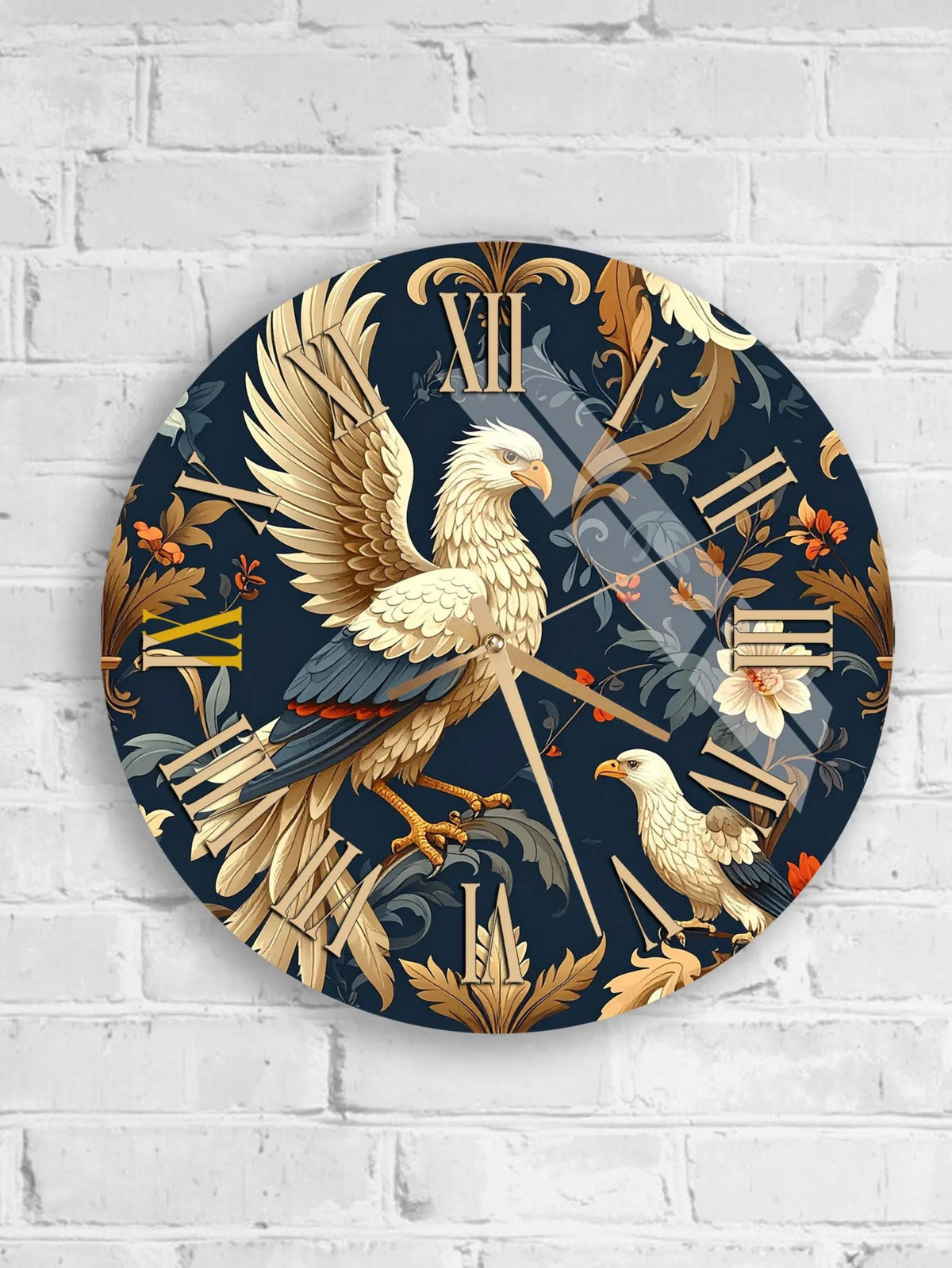 A round wall clock with a detailed design featuring a white bird, possibly a hawk or an eagle, against a dark blue background with floral and leaf patterns.
