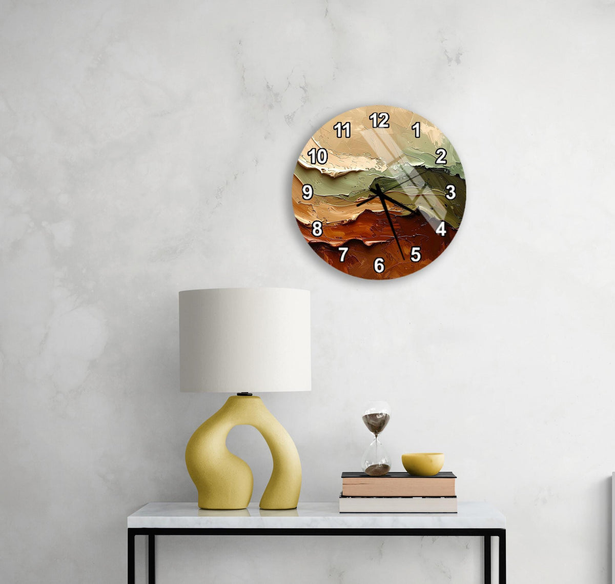 a modern wall clock with a unique design, a yellow lamp on a white table, and a stack of books and a glass of wine on the table.