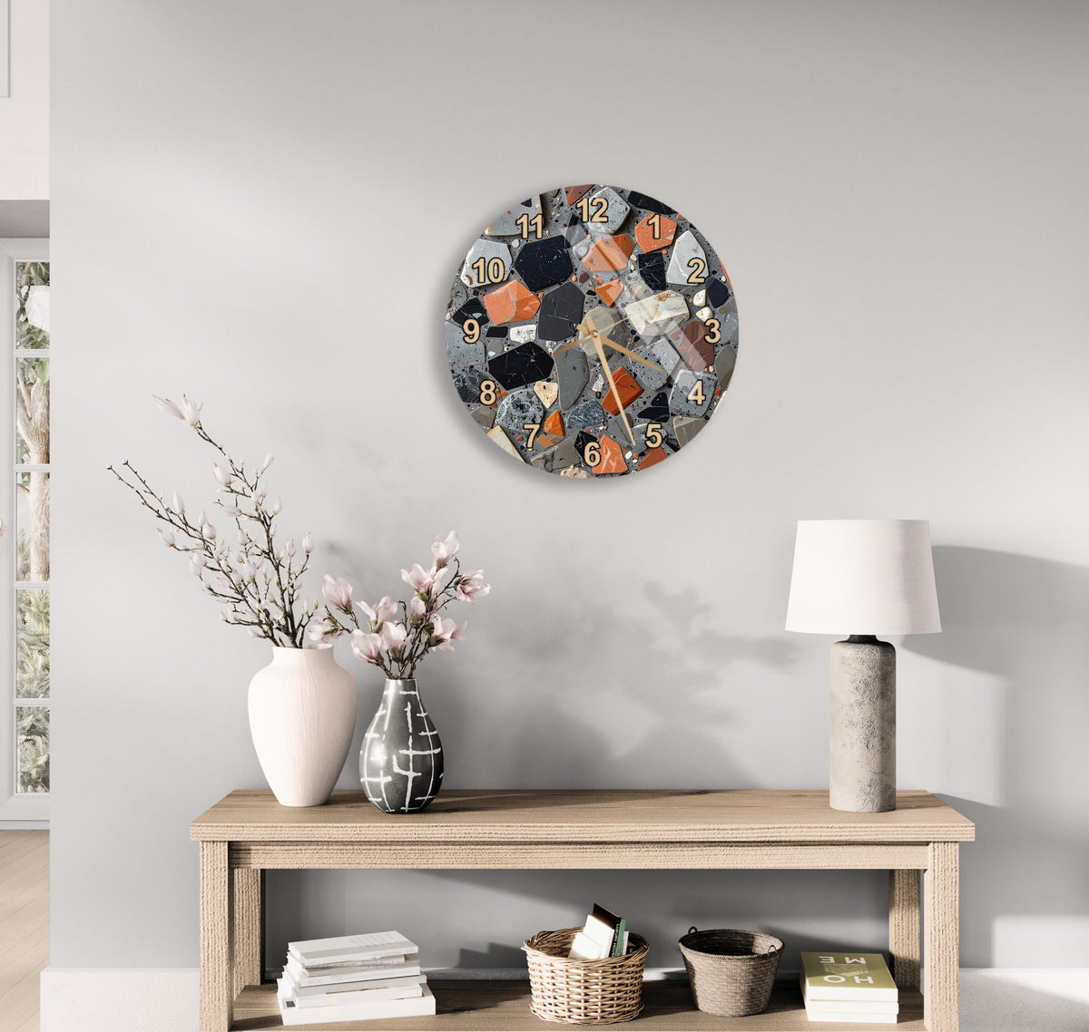a modern living room with a wooden console table, a round wall clock, and various decorative items such as a vase with flowers, a lamp, and a stack of books.