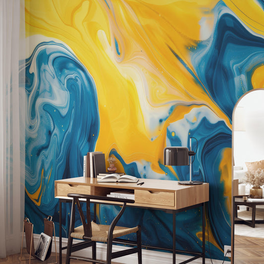 a modern workspace with a wooden desk and a black chair. The desk has a lamp and a few books on it. The wall behind the desk has a vibrant, abstract design in shades of yellow, blue, and white.