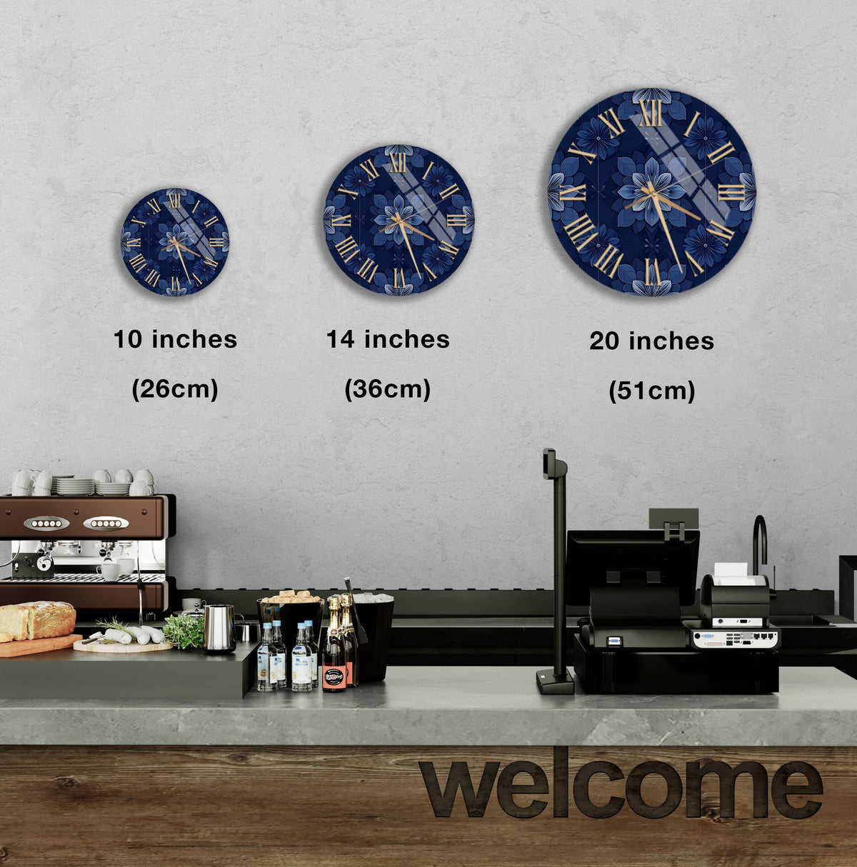 a wall with three clock faces of different sizes, each displaying a blue floral design. Below the clock faces, there is a counter with various items such as bottles and a cash register. The word "welcome" is written on the counter.