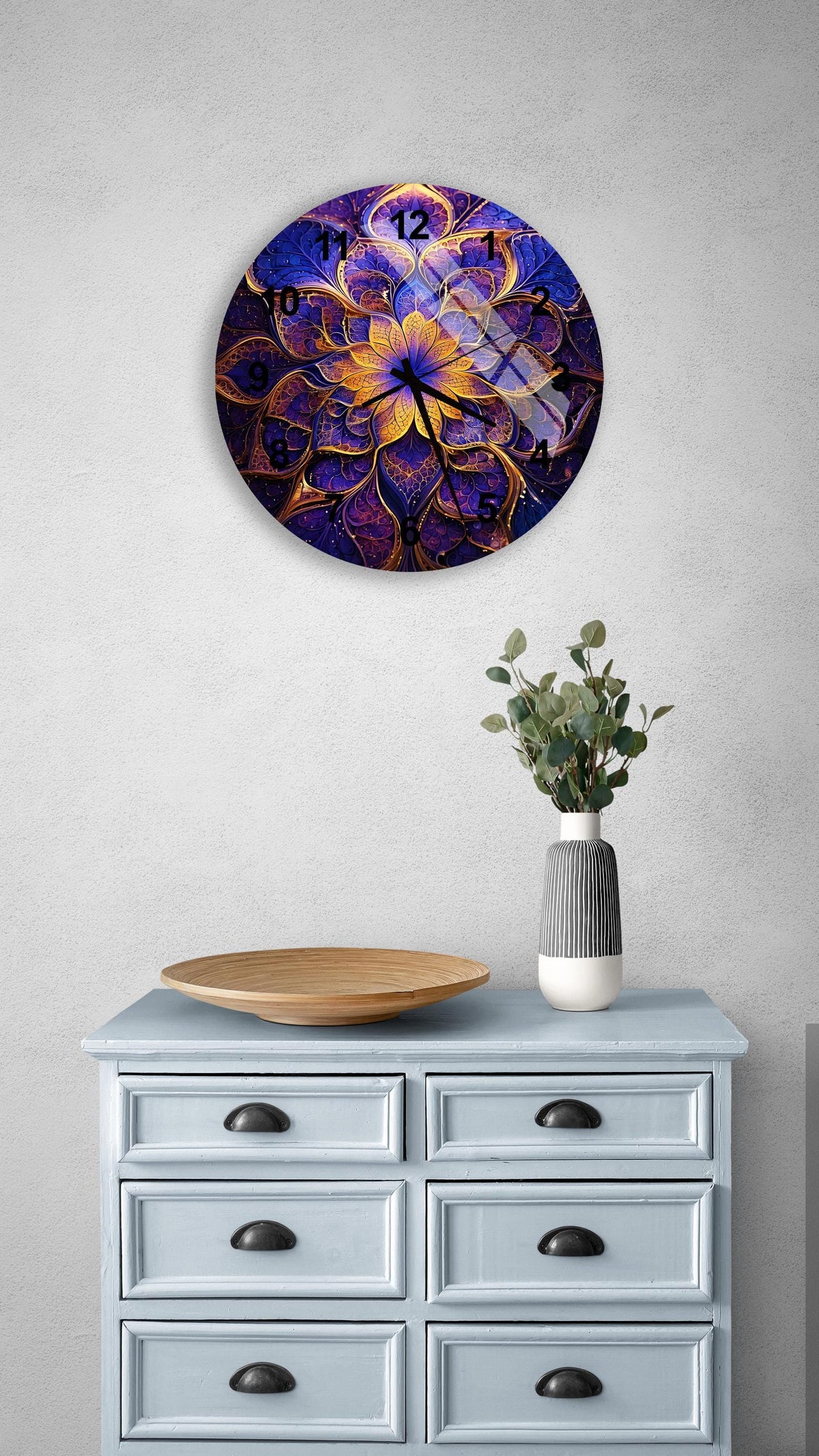 a blue dresser with a vase of flowers on top of it