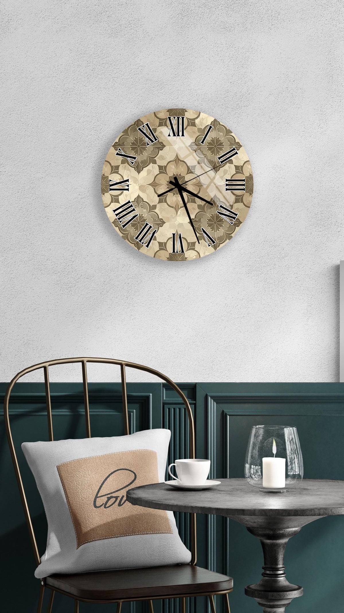 a wall clock with a floral design, a round table with a white cup and a lit candle, and a chair with a pillow on it.