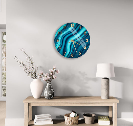 a modern living room with a wooden console table, a round wall clock with a blue and white swirl design, a white vase with pink flowers, a white lamp, and a stack of books.