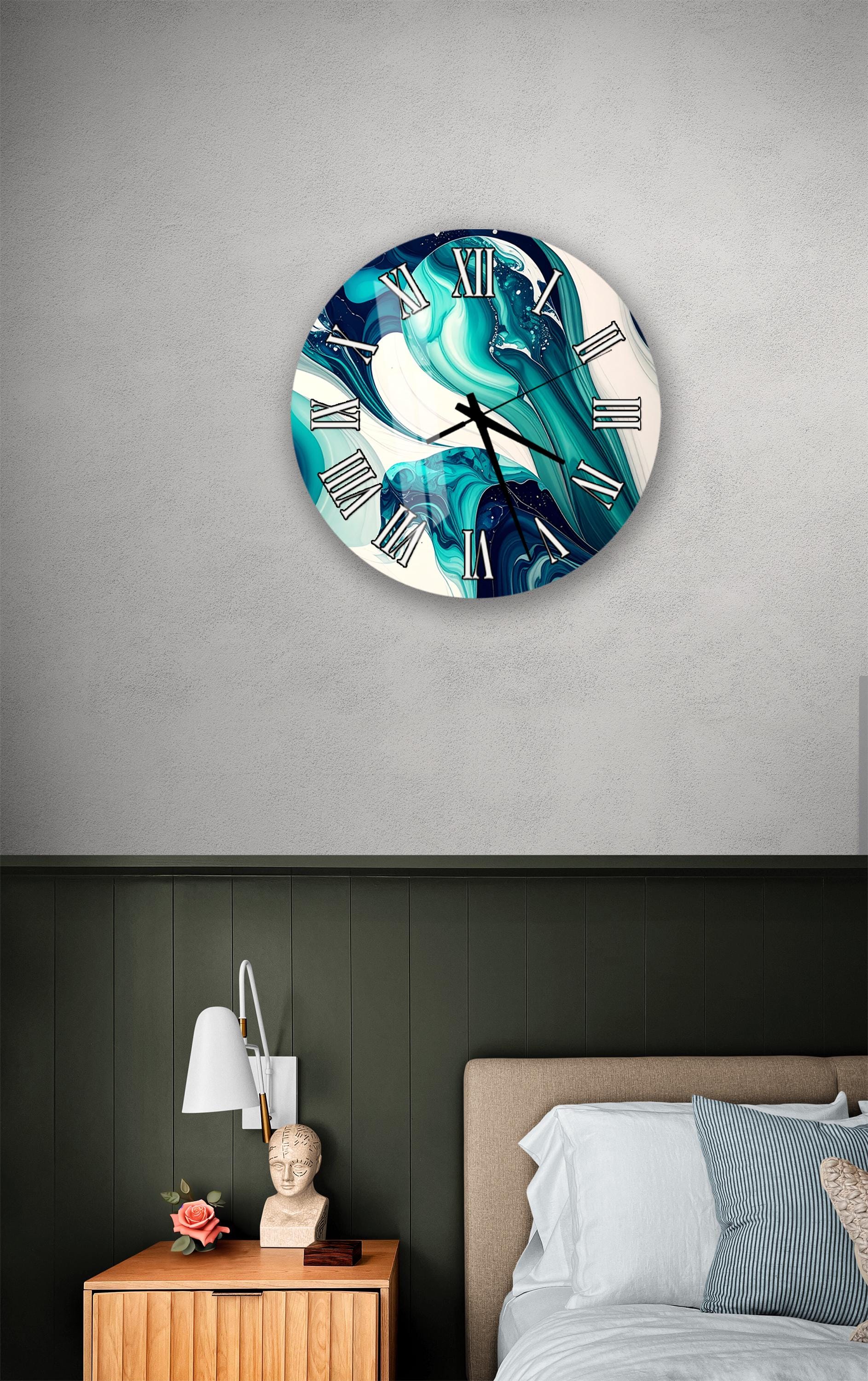 a bedroom setting with a large, round clock hanging on the wall above a bed. The clock has a unique, swirling design in shades of blue and green. The room also includes a nightstand with a lamp and a small statue or bust.