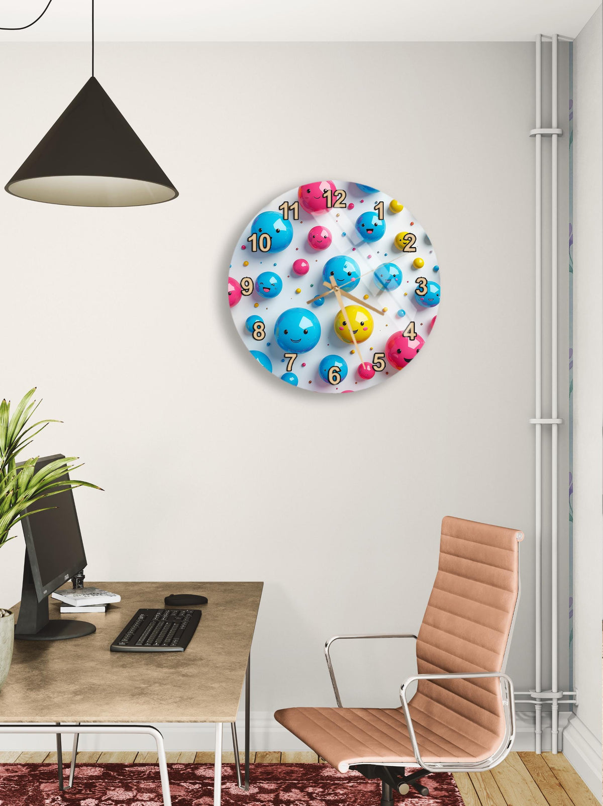 a modern office space with a large clock featuring colorful balls and numbers on the wall. The clock is mounted above a desk with a computer monitor, keyboard, and mouse. A brown leather office chair is positioned in front of the desk, and a potted plant is visible in the background.