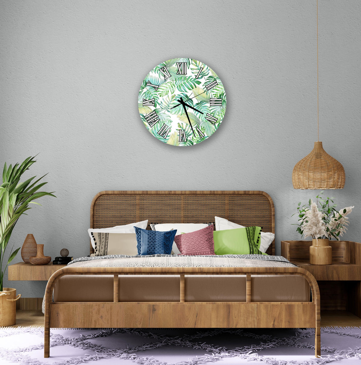 a bedroom with a large bed, a wicker headboard, and a wall clock with a tropical leaf pattern. The room has a neutral color scheme with a wicker pendant light and a woven basket.