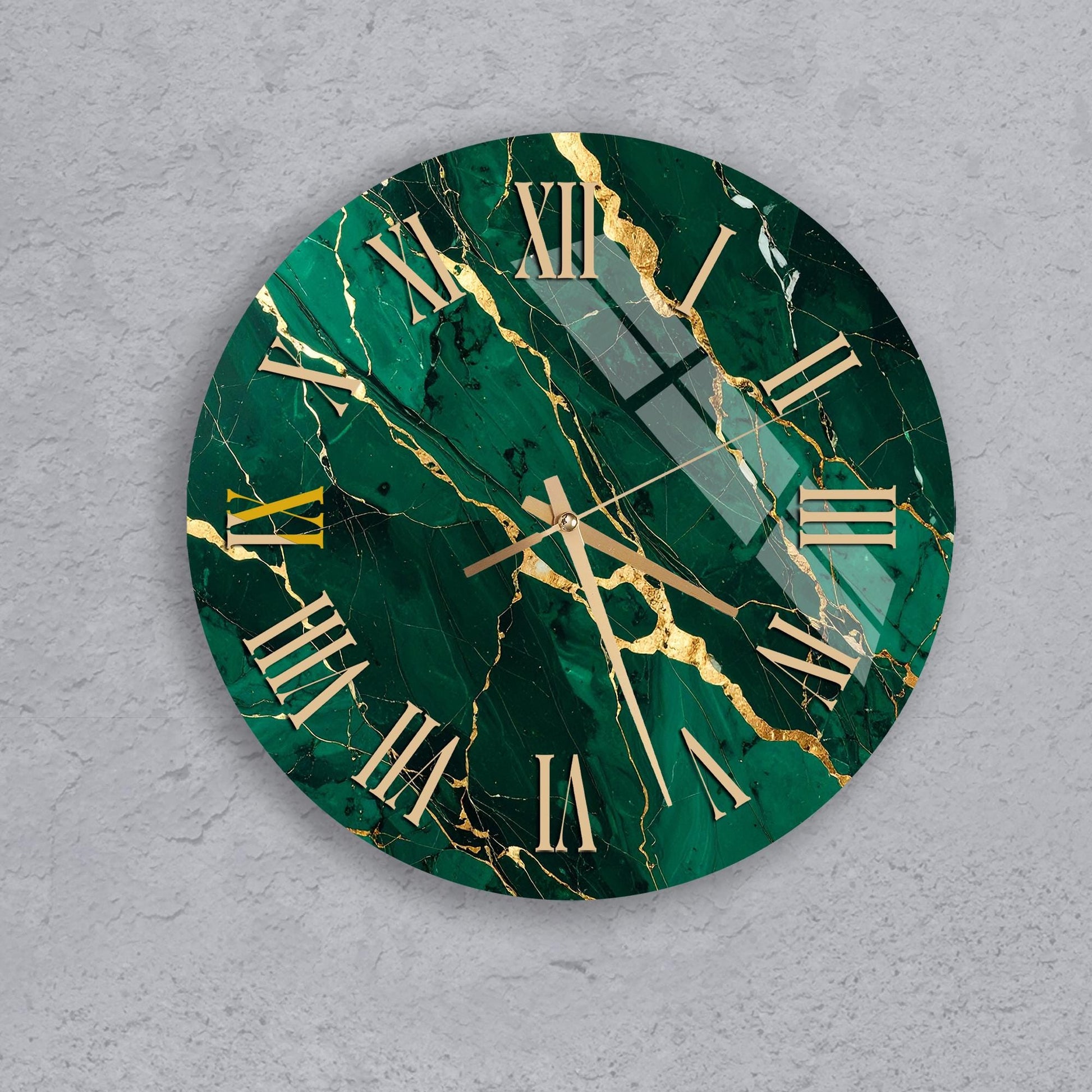 A round wall clock with a green marble-like background and gold Roman numerals.
