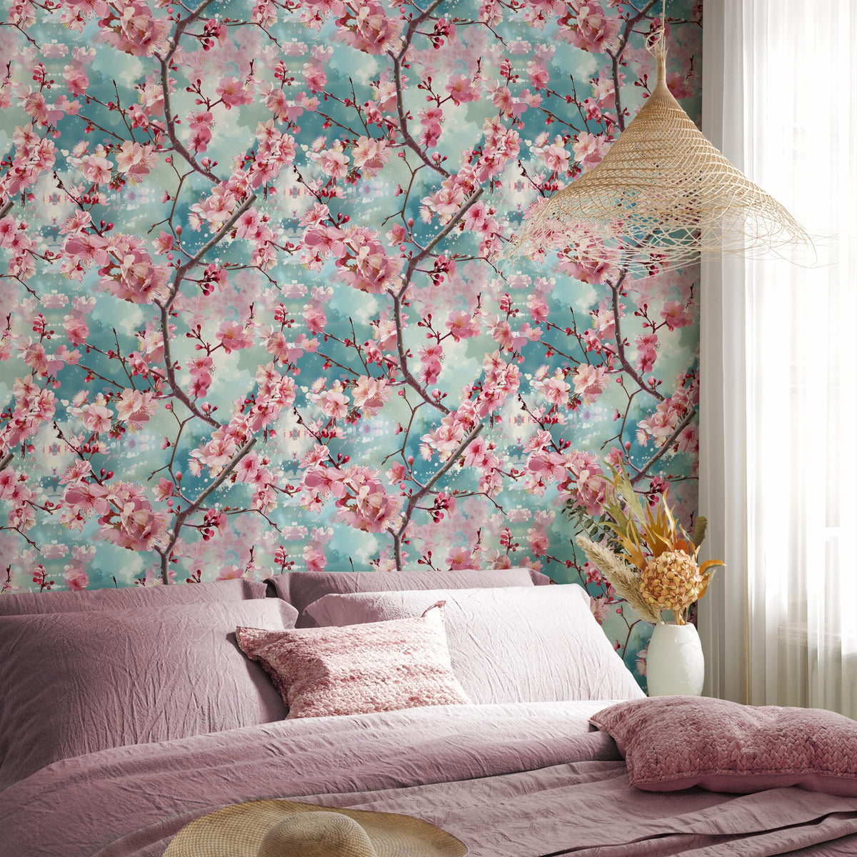 a bedroom with a large floral wallpaper featuring pink and green flowers. The room has a bed with purple bedding and a white pillow, and a woven light fixture is hanging above the bed. There is a vase of flowers on the nightstand next to the bed.