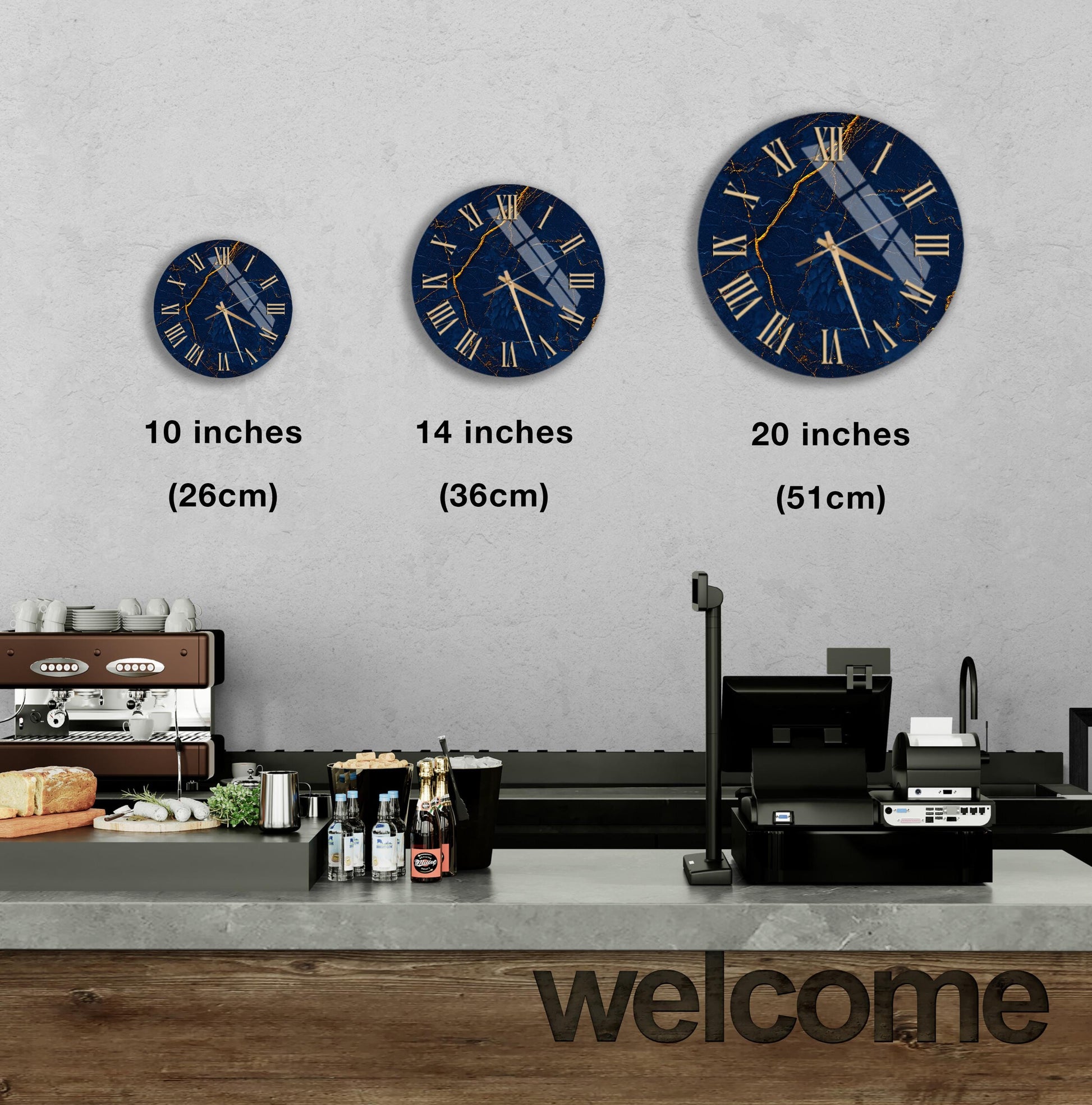 a wall with three clock faces of different sizes, each displaying the same time. Below the clock faces, there is a counter with various items such as bottles and a sandwich. The word "welcome" is written on the counter.