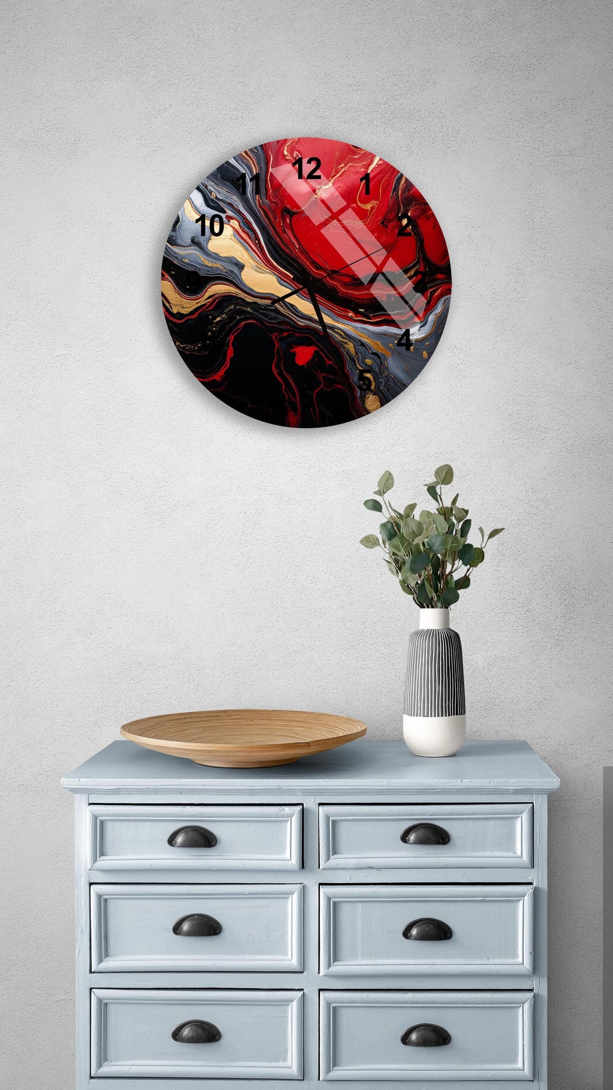a blue dresser with a vase of flowers on top of it