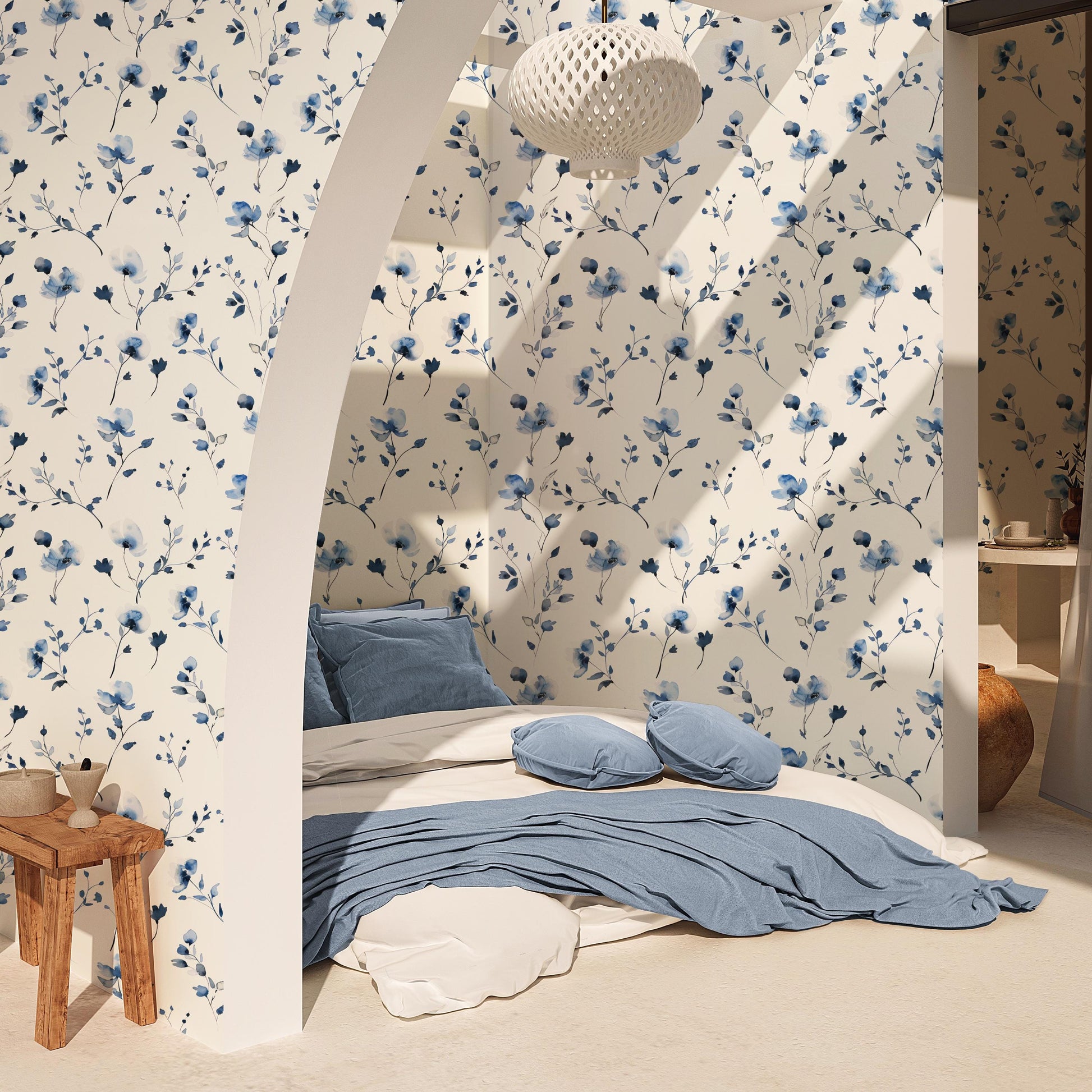 a cozy bedroom with a floral wallpaper, a comfortable bed with blue and white bedding, and a wooden side table.