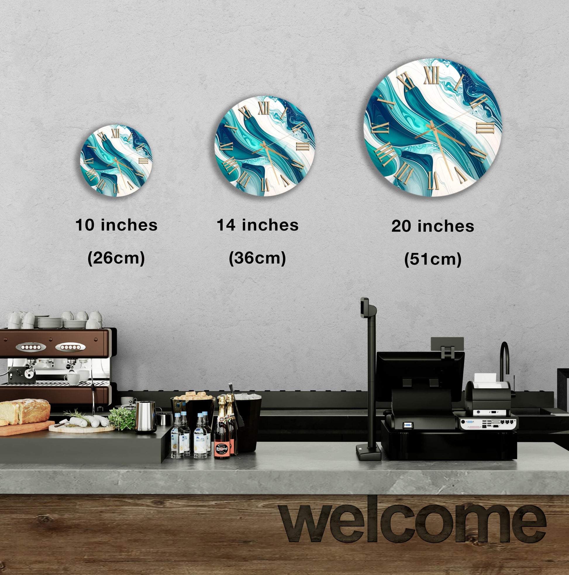 a wall with three clock designs of different sizes, and there is a counter with various items on it, such as bottles and a sandwich.